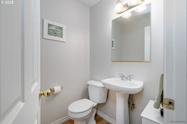 24788 E Mckenzie Valley Ct, Welches, OR 97067 - bathroom with baseboards, toilet, and wood finished floors