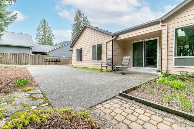 24788 E Mckenzie Valley Ct, Welches, OR 97067 - rear view of house featuring a patio and fence
