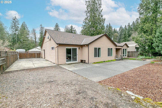24788 E Mckenzie Valley Ct, Welches, OR 97067 - back of house with a patio area, roof with shingles, driveway, and fence