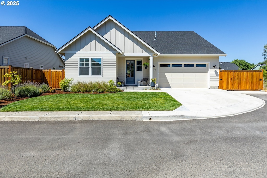 view of front of house with a front yard and a garage