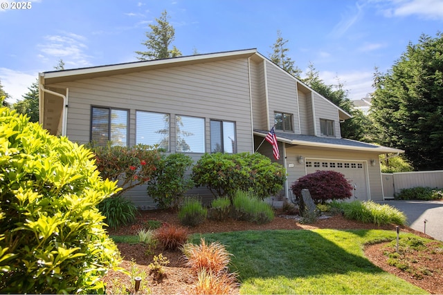 view of front of house featuring a garage and a front lawn