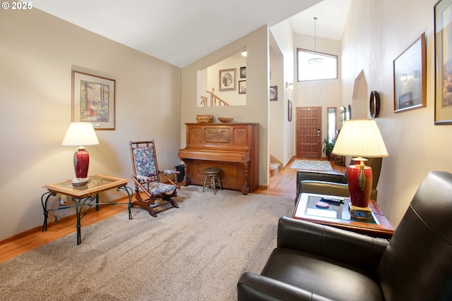 sitting room featuring hardwood / wood-style floors and high vaulted ceiling