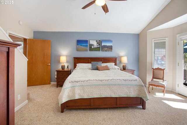 bedroom featuring vaulted ceiling, light colored carpet, and ceiling fan