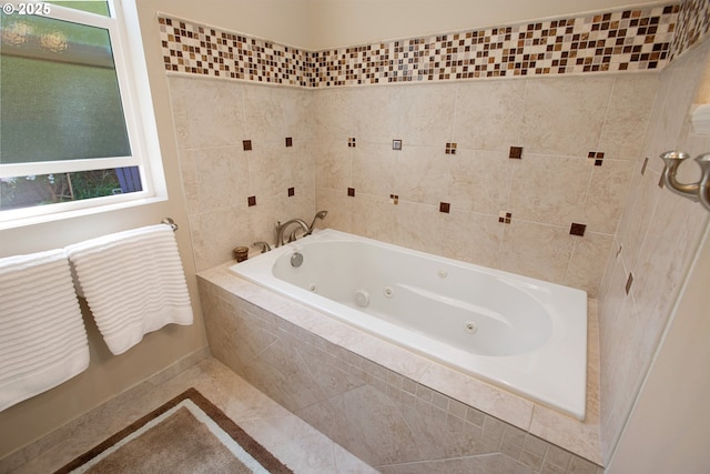 bathroom featuring tile patterned flooring and tiled tub