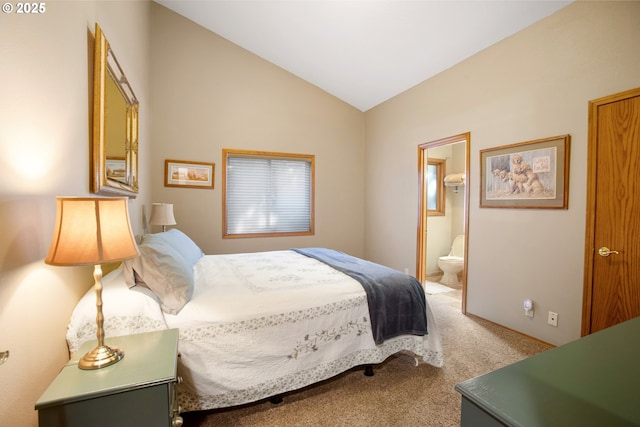 carpeted bedroom featuring ensuite bathroom and vaulted ceiling