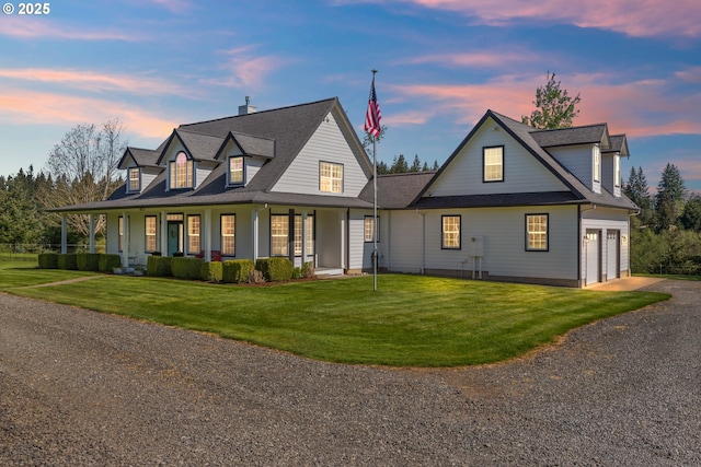 view of front of home featuring a front yard, roof with shingles, covered porch, and driveway