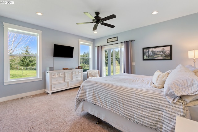 bedroom with recessed lighting, baseboards, and light carpet