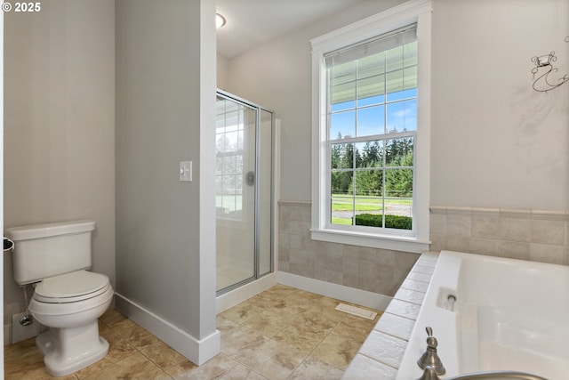 bathroom featuring toilet, tile patterned flooring, a shower stall, and a bath