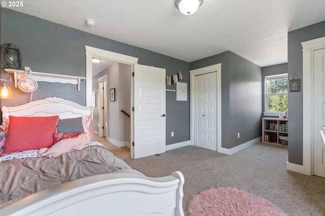 carpeted bedroom with baseboards