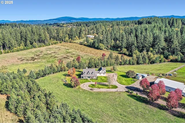 bird's eye view with a mountain view and a forest view