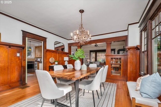 dining room featuring crown molding, ceiling fan with notable chandelier, and light hardwood / wood-style floors