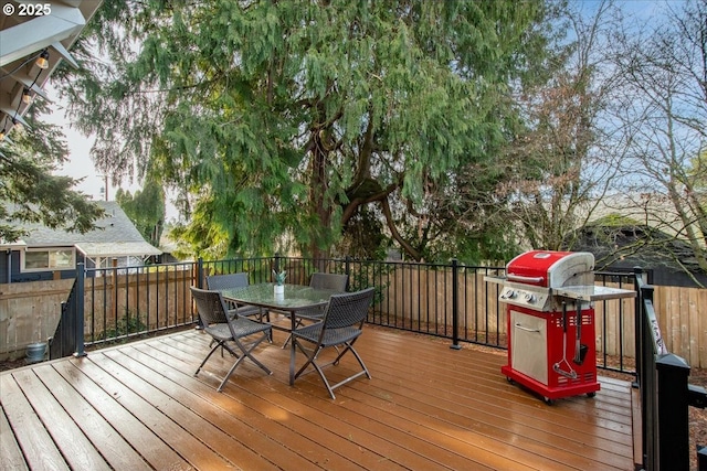 wooden terrace featuring a grill