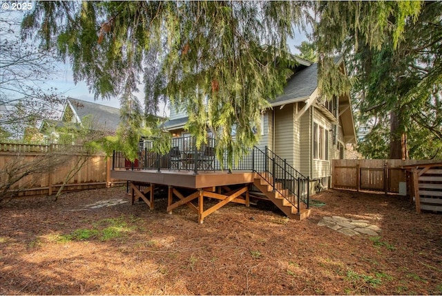 back of property featuring a wooden deck