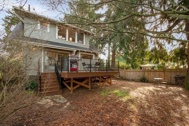 rear view of house featuring a deck