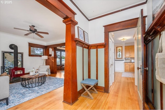 interior space with ornamental molding, light hardwood / wood-style floors, and decorative columns