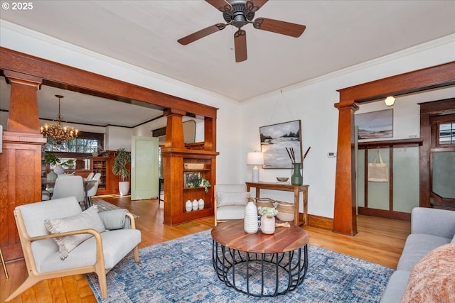 sitting room featuring crown molding, ceiling fan with notable chandelier, and light hardwood / wood-style floors