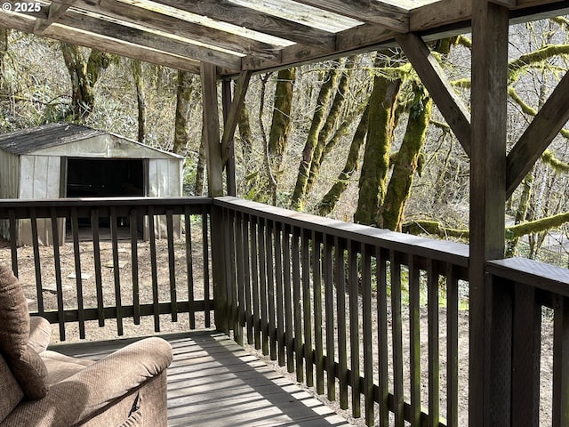 deck featuring a shed and an outdoor structure