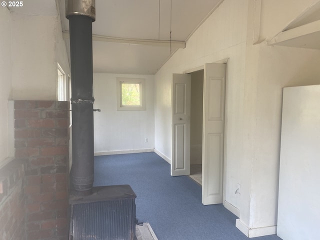 corridor with dark carpet and baseboards