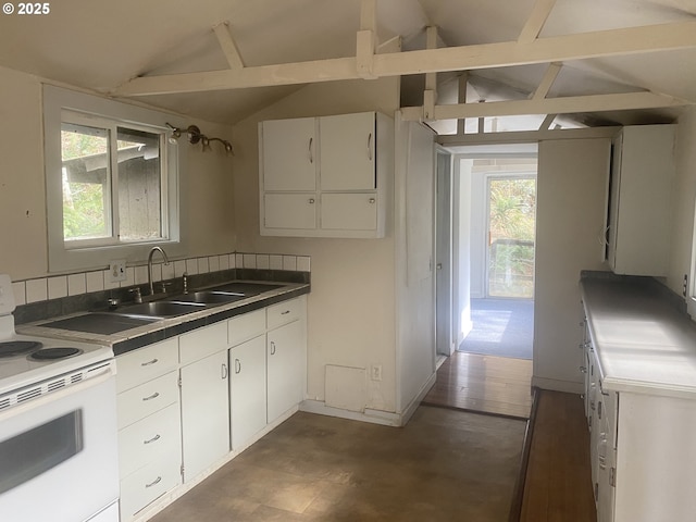 kitchen featuring vaulted ceiling, white range with electric cooktop, a sink, and white cabinetry