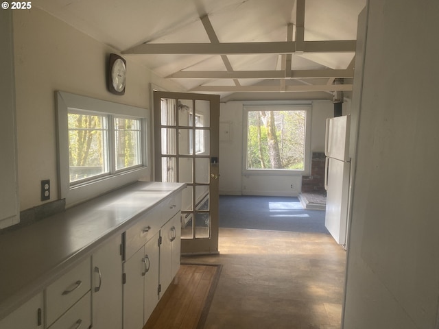 entryway featuring vaulted ceiling with beams