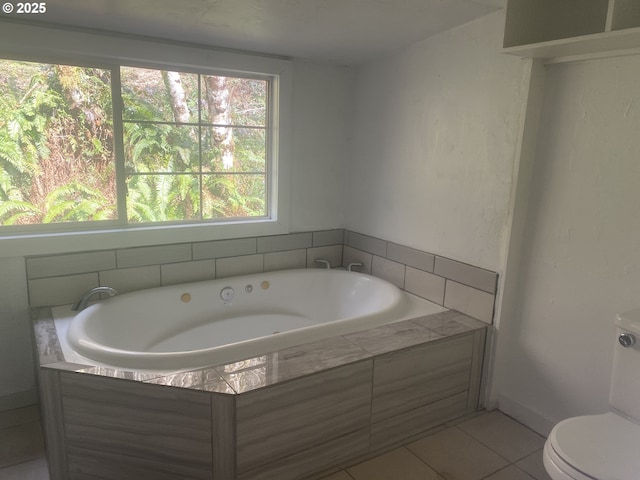 full bath with toilet, tile patterned flooring, and a bath