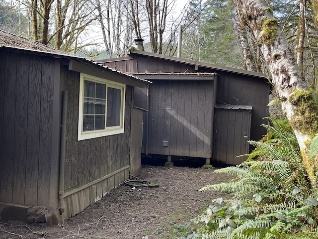 exterior space featuring metal roof and an outdoor structure