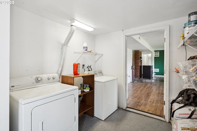 washroom with washer and dryer, laundry area, and visible vents
