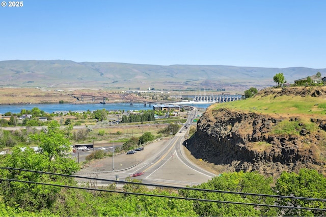 birds eye view of property with a water and mountain view