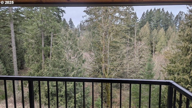 balcony featuring a view of trees