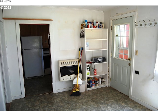 kitchen with freestanding refrigerator and heating unit