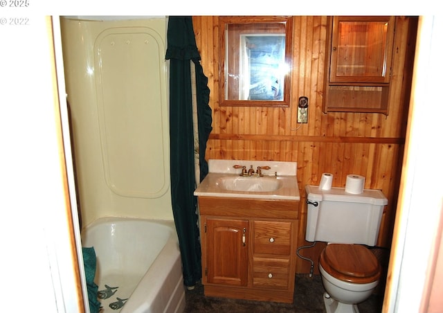 full bathroom featuring toilet, wood walls, vanity, and shower / bath combo with shower curtain