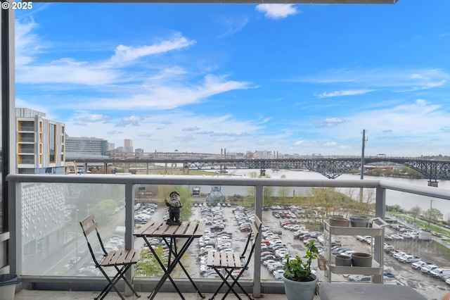 balcony featuring a water view and a view of city