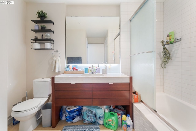 bathroom featuring toilet, tiled shower / bath combo, and vanity