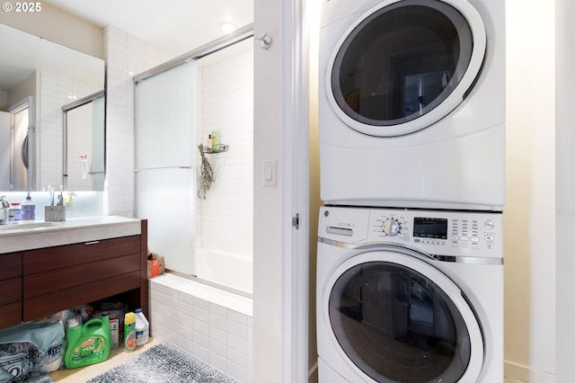 laundry area with stacked washer / dryer and a sink