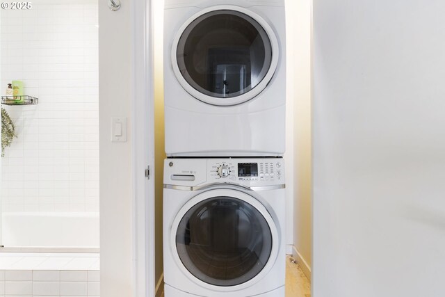 laundry room with stacked washer and clothes dryer and laundry area