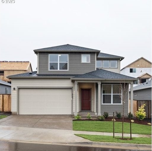 view of front of house featuring a front yard and a garage