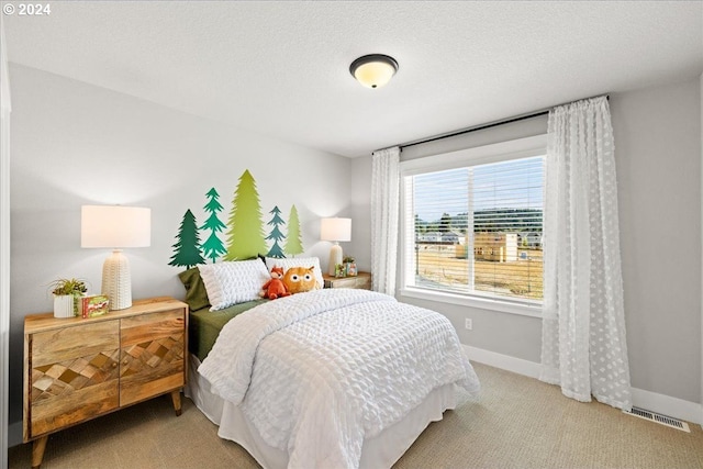 carpeted bedroom featuring a textured ceiling