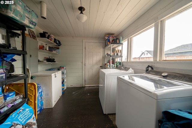 clothes washing area with washer and clothes dryer, wood ceiling, and dark wood-style flooring
