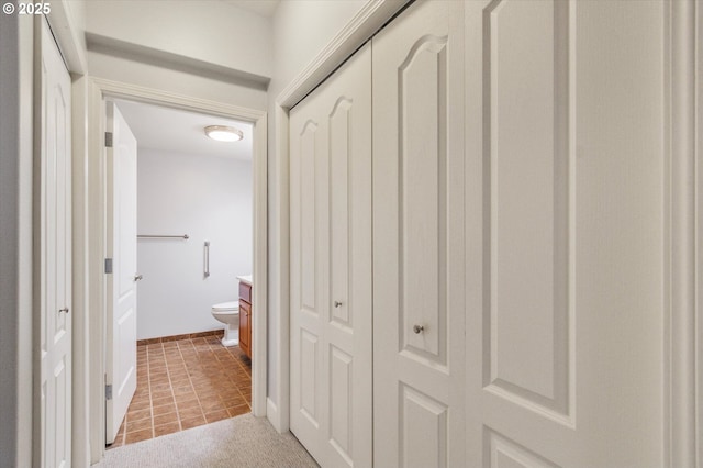 hallway with light colored carpet