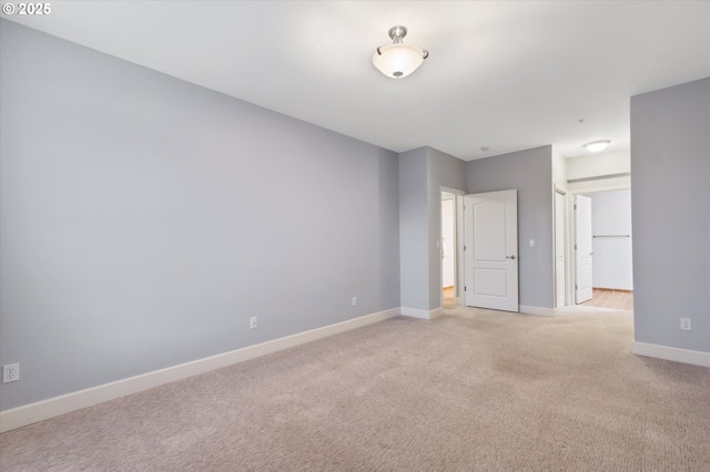 unfurnished room featuring light carpet