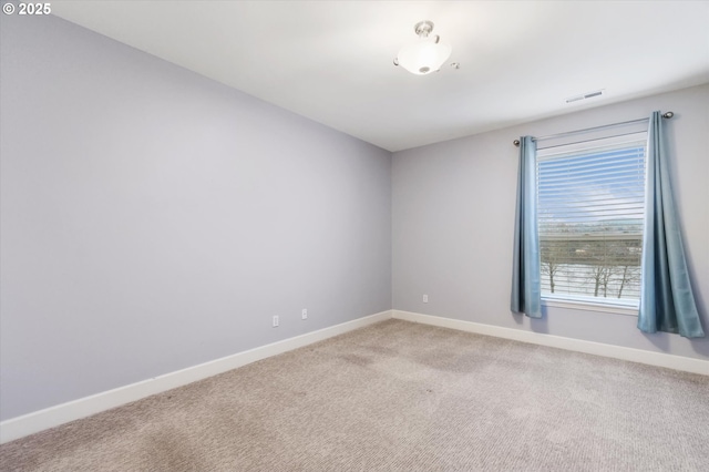 unfurnished room featuring light colored carpet