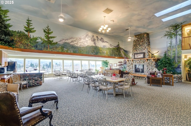 carpeted dining space featuring a fireplace, a chandelier, and a high ceiling