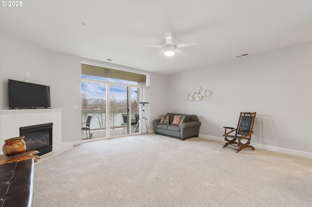 sitting room with light carpet and ceiling fan