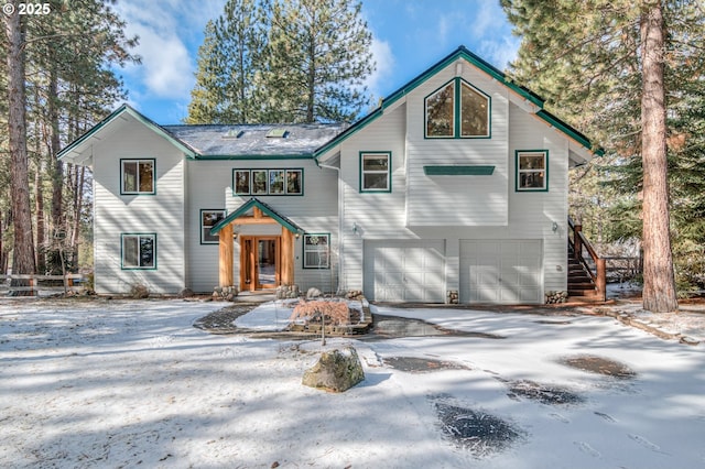 view of front of house featuring driveway, stairway, and an attached garage