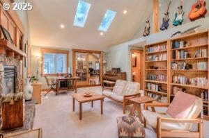 living area featuring vaulted ceiling with skylight and a fireplace with raised hearth