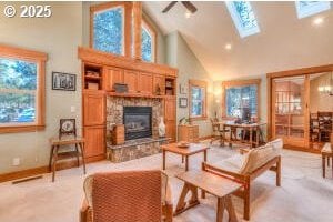 living area with a skylight, a fireplace, and high vaulted ceiling