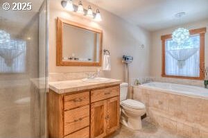 bathroom featuring toilet, a shower with door, tile patterned flooring, vanity, and a bath