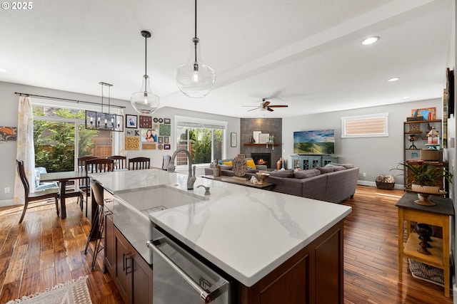 6244 SE Jess Ct, Hillsboro, OR 97123 - kitchen featuring ceiling fan, a sink, a fireplace, dishwasher, and baseboards