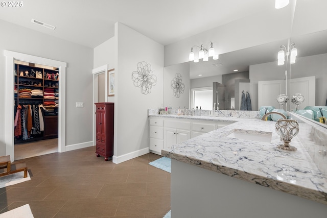 6244 SE Jess Ct, Hillsboro, OR 97123 - full bathroom featuring visible vents, vanity, baseboards, a walk in shower, and a spacious closet