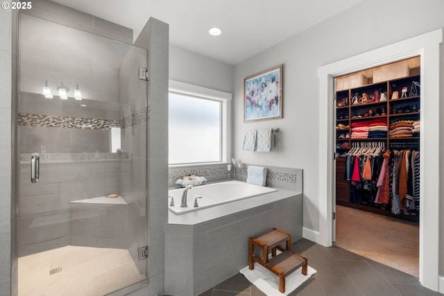 6244 SE Jess Ct, Hillsboro, OR 97123 - bathroom featuring a bath, tile patterned flooring, a stall shower, baseboards, and a spacious closet